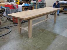 man looking at wooden table